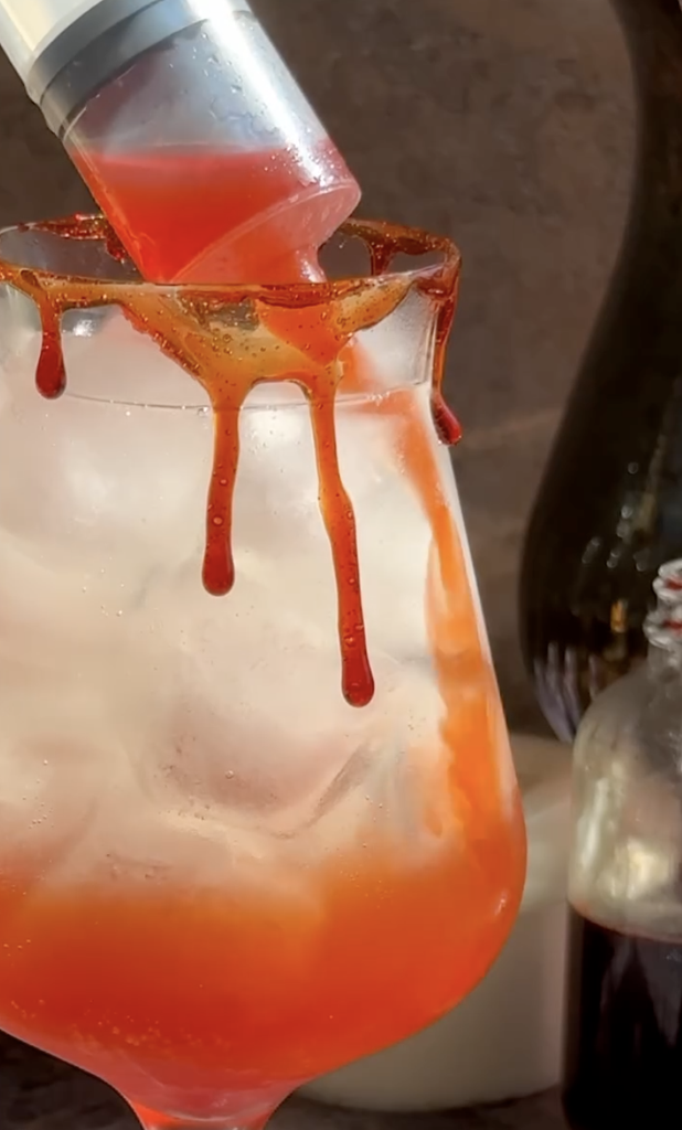 bloody halloween aperol spritz with syringe