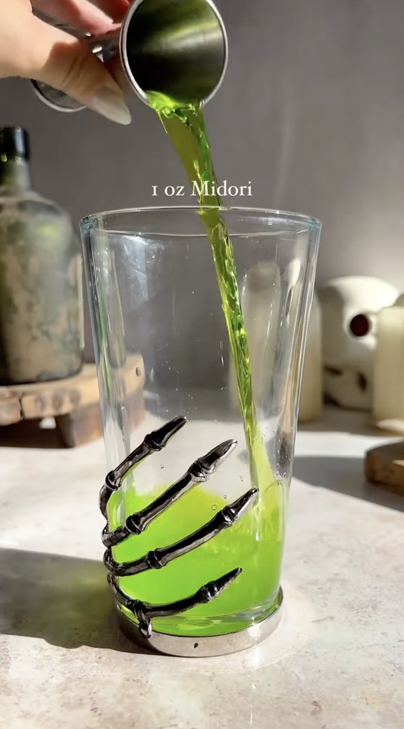Beetlejuice midori sour ingredient, midori, being poured
