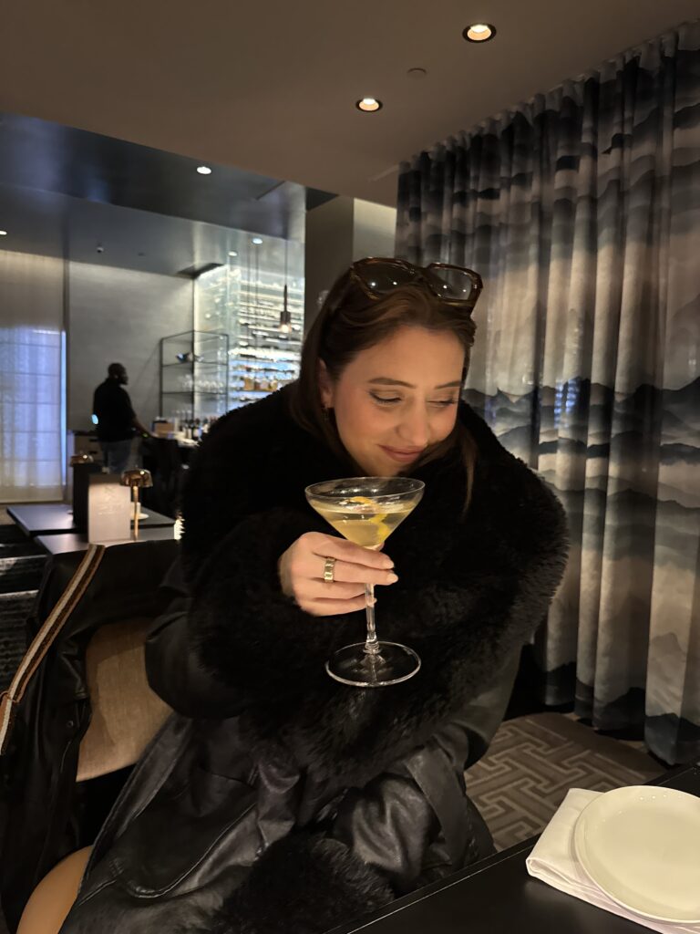 Jules drinking a martini