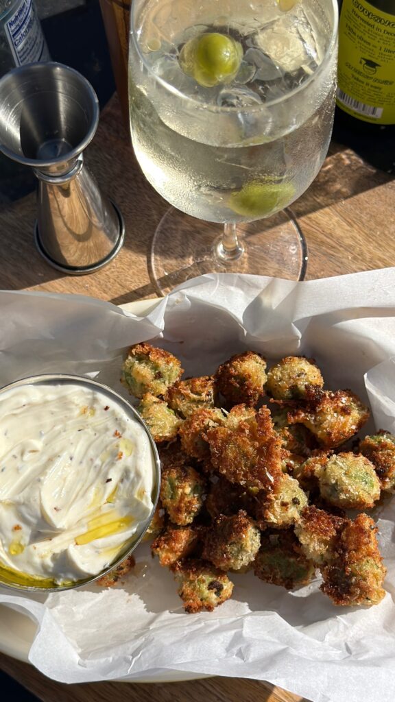fried olives with whipped ricotta and a martini